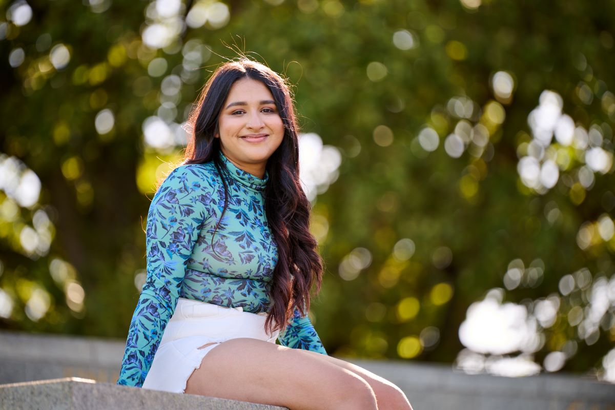 Rutvi smiling with trees in the background