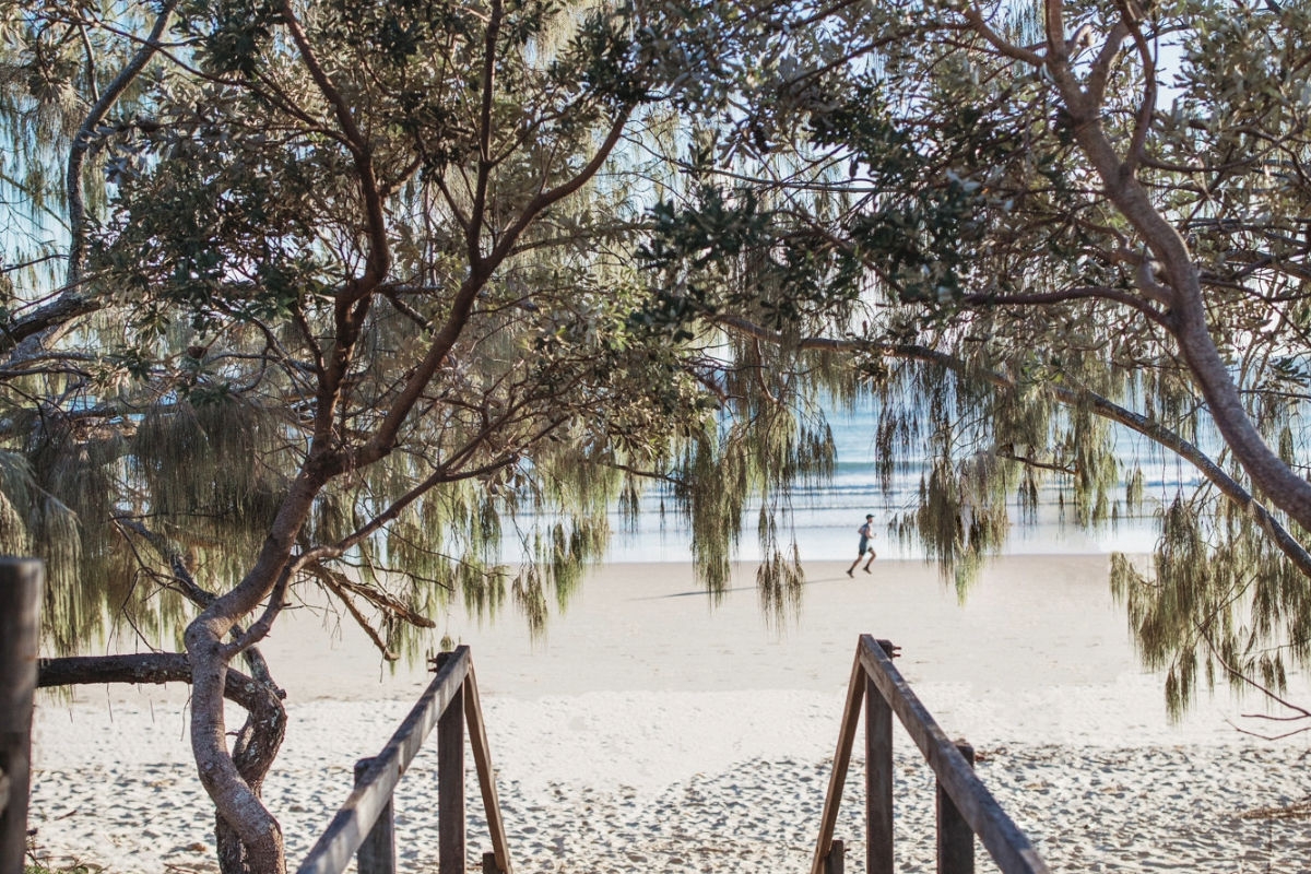 Mooloolaba beach with a man jogging